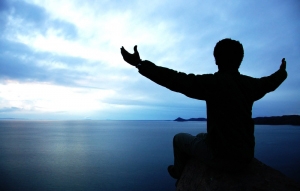 silhouette of man reaching out to the sky