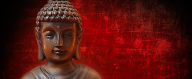 Buddha statue on red background