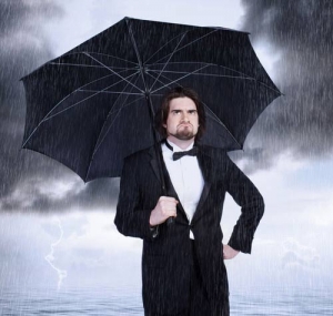 grumpy man holding umbrella in rain