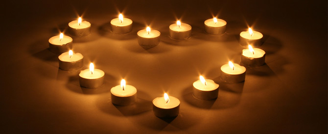 tea lights burning in a heart shape arrangement