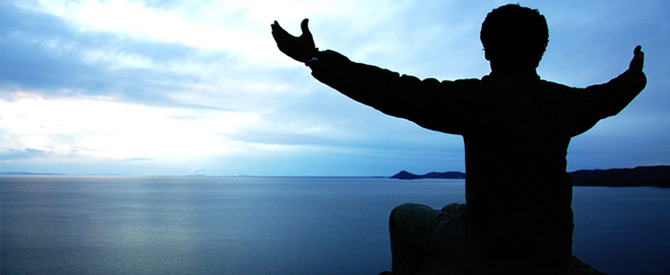 man silhouette reaching for the sky