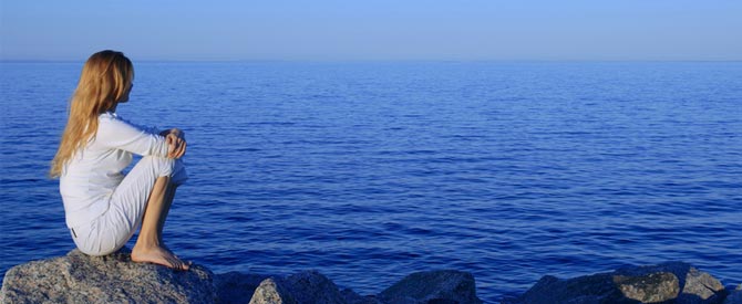 woman contemplating by ocean