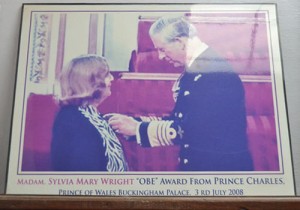 Madam Sylvia Wright receiving the Order of the British Empire award from Prince Charles in 2008.