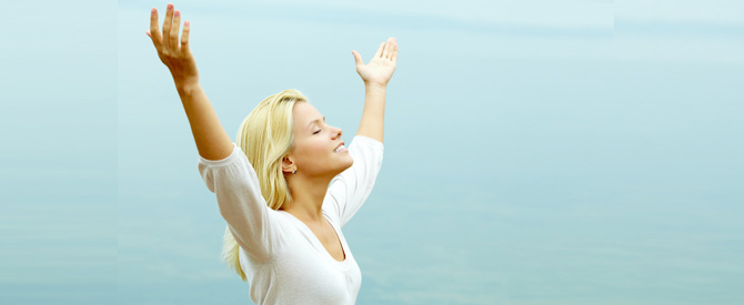 smiling bond woman with hands outstretched.