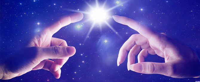 a male and a female hand with index fingers pointing to a star on a star studded background.