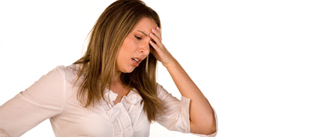stressed out woman with hand on her forehead