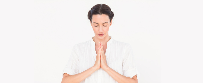 woman with hands in the praying position representing the highest spiritual discipline of gaining oneness with the Self within.