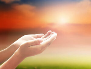 open empty hands with palms up surrendering your worries and fears and asking for divine grace