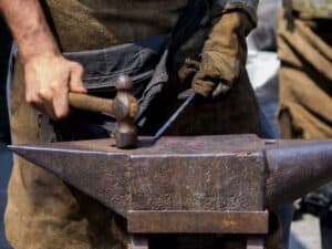 image of Blacksmith hammering on anvil to show that the true self is changeless.