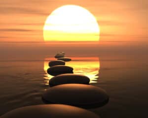 stepping stones in the water leading to the sun symbolizing how to live and die happily