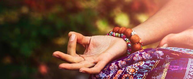 Closeup of woman hand in mudra gesture ready to recite a mantra