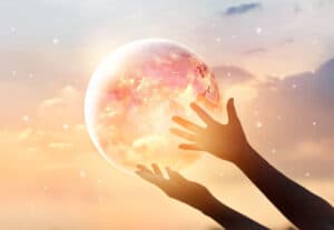 hands holding planet earth to show our responsbilities as members of one cosmic family