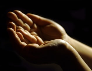 hands being held out to receive blessings showing that acceptance is a way to get over sorrow.
