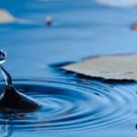 Water droplet bouncing out of the water representing how to measure your inner growth.