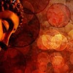 Bronze red meditating Buddha statue representing living in awareness of your true self.
