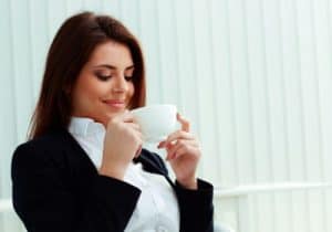 smiling woman enjoying her morning cup of coffee