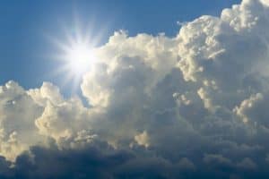 Sun peeking through the clouds symbolising how to find God as the light