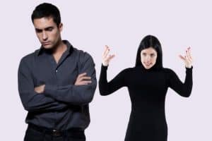 Woman in heated argument with a man trying to end conflict.jpg
