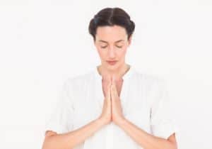 Woman with folded hands showing prayer as a means to overcome anger