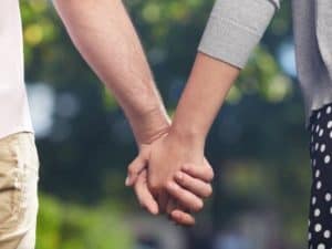 Man and woman hand in hand walking together living a spiritual life