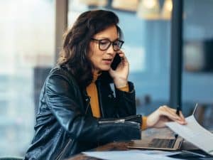 Woman working at her desk while dedicating her actions to build a connection to God